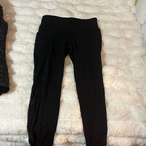 Athleta black leggings with side pockets and mesh detailing on sides
